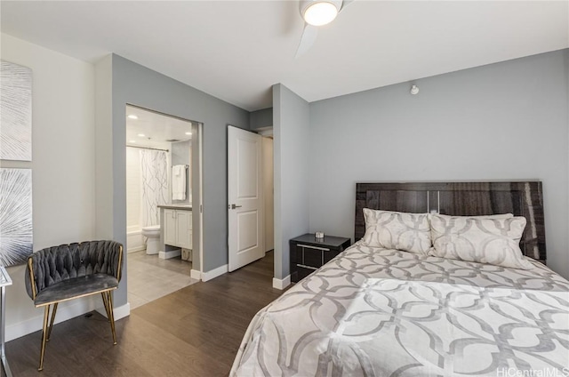 bedroom with wood-type flooring and ensuite bath