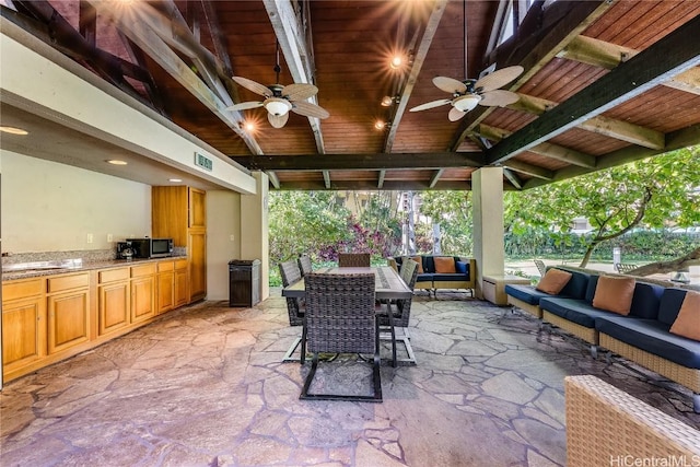 view of patio / terrace featuring an outdoor living space, area for grilling, and ceiling fan