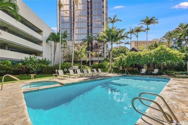 view of pool with a hot tub