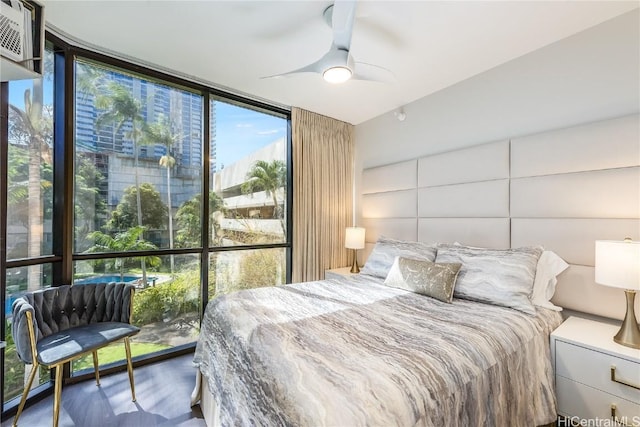 bedroom featuring a wall of windows and ceiling fan