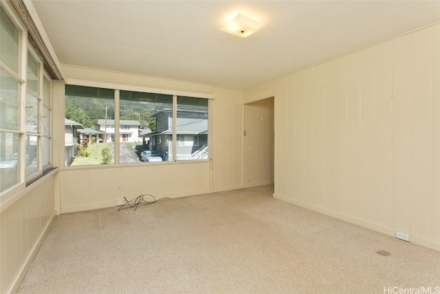 unfurnished room featuring light colored carpet