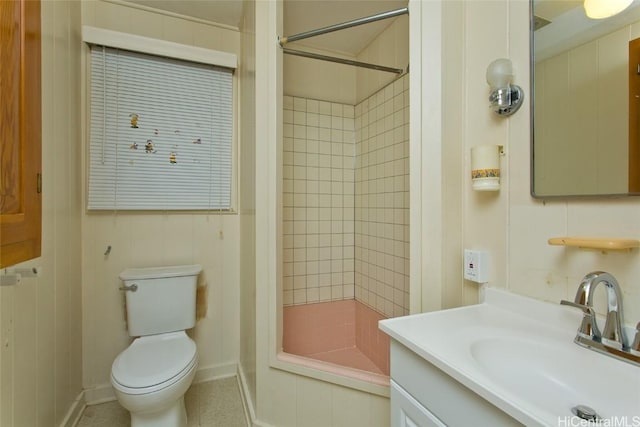 bathroom with vanity, tiled shower, and toilet