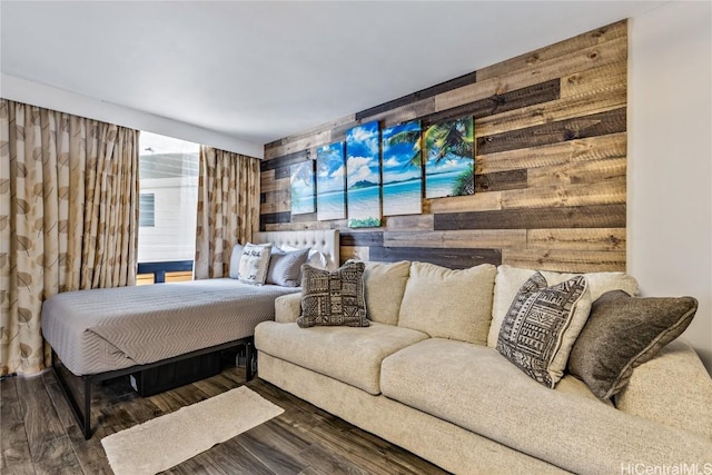 bedroom featuring dark hardwood / wood-style flooring and wooden walls