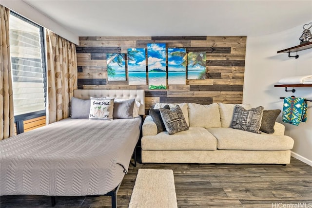 bedroom with dark hardwood / wood-style flooring and wooden walls