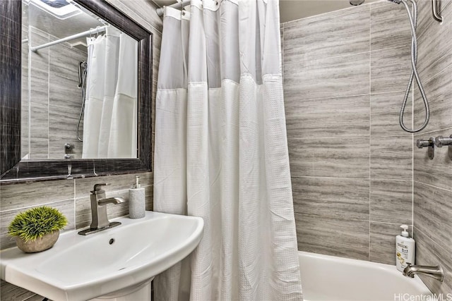 bathroom featuring shower / tub combo, sink, and backsplash