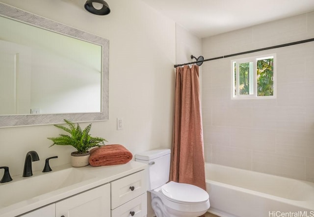 full bathroom featuring vanity, shower / bath combination with curtain, and toilet