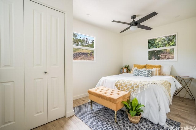 bedroom featuring light hardwood / wood-style flooring, a closet, and ceiling fan