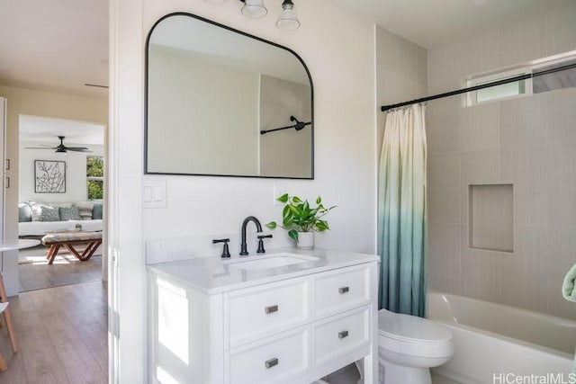 full bathroom with toilet, vanity, shower / bath combination with curtain, ceiling fan, and hardwood / wood-style floors