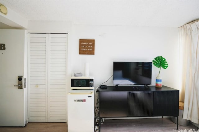 interior space featuring hardwood / wood-style floors and a textured ceiling