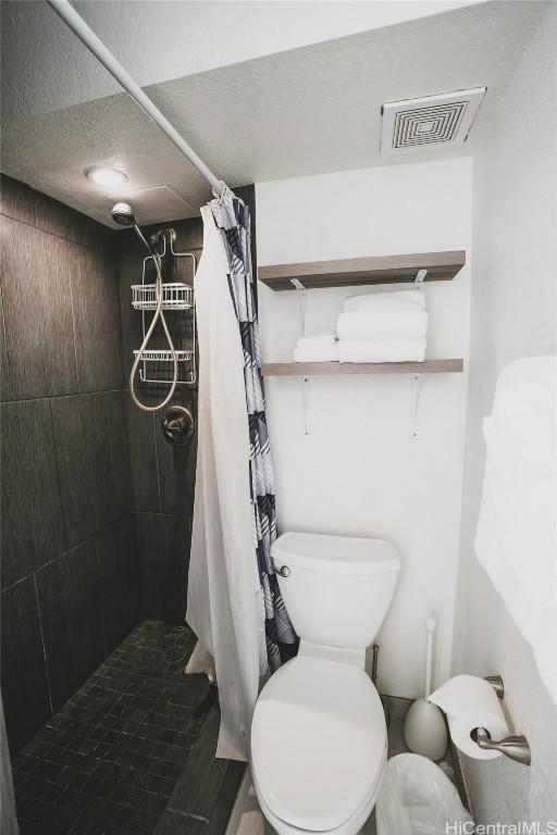 bathroom with toilet and walk in shower