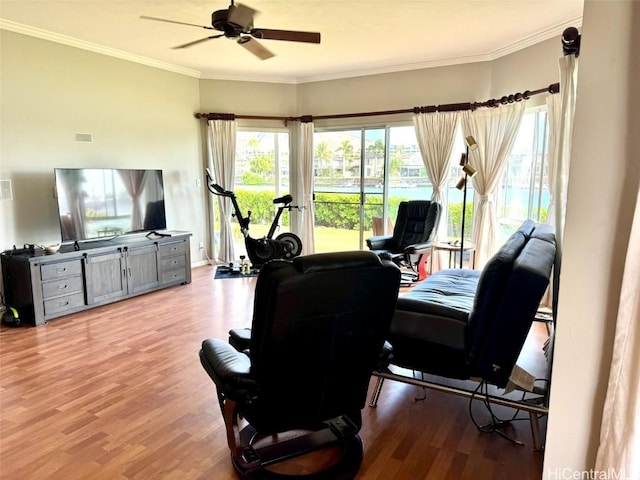 office area with crown molding, ceiling fan, and light wood-type flooring