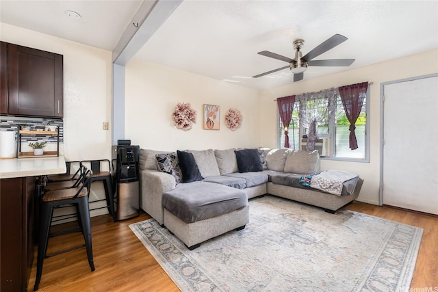 living area with light wood-style flooring and ceiling fan