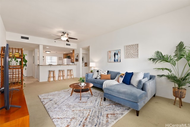 living room with ceiling fan and carpet floors