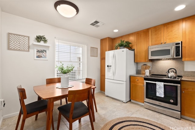 kitchen featuring stainless steel appliances and backsplash