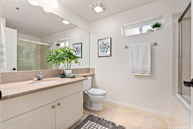 bathroom featuring vanity, a shower with door, and toilet