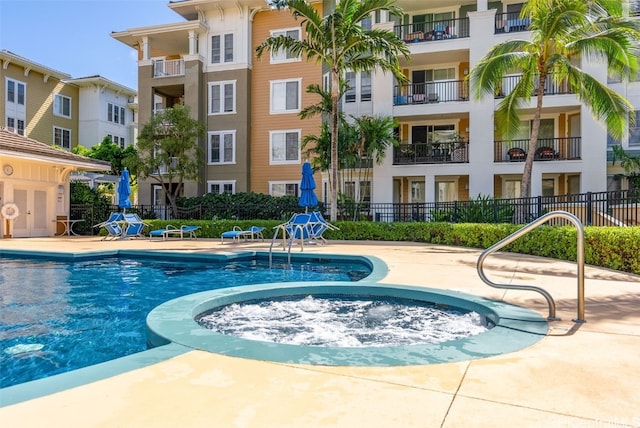 view of pool with a community hot tub and a patio