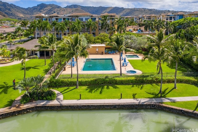 view of pool featuring a patio area and a water and mountain view