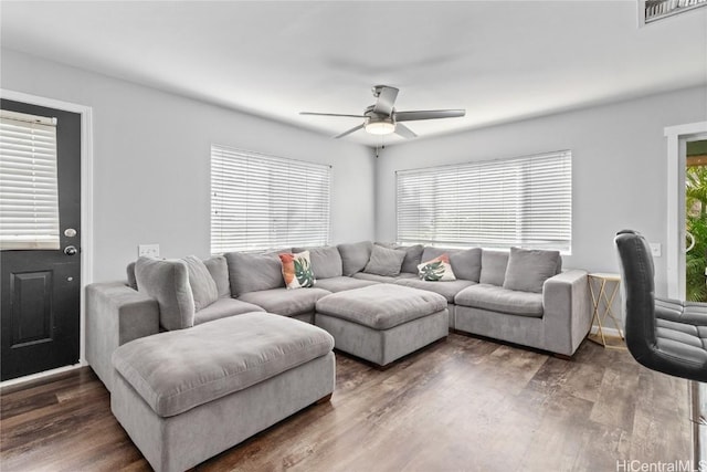 living room featuring dark hardwood / wood-style floors and ceiling fan