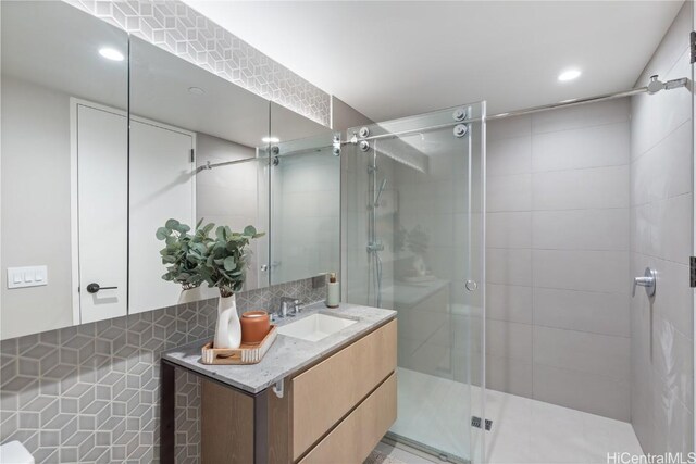 1000 Auahi St Unit 2505, Honolulu, HI 96814 - bathroom featuring a stall shower, backsplash, vanity, and recessed lighting
