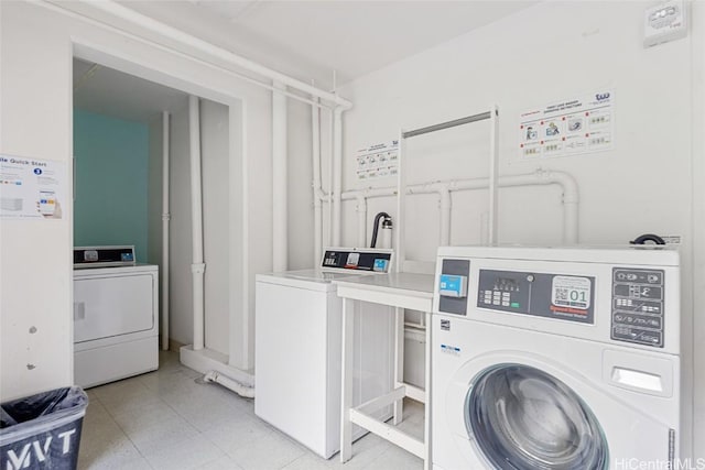 clothes washing area with washer and dryer