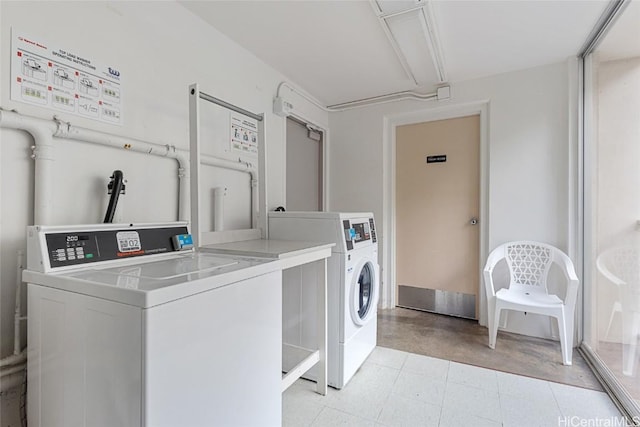 clothes washing area featuring independent washer and dryer