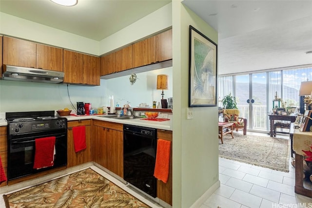 kitchen featuring light tile patterned flooring, sink, floor to ceiling windows, and black appliances