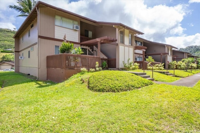 rear view of property featuring a yard