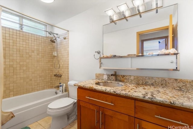 full bathroom with tile patterned flooring, tiled shower / bath, vanity, and toilet