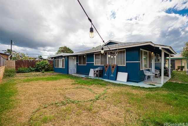 back of property featuring a lawn