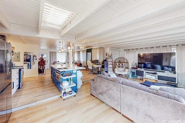 living room featuring beam ceiling and light wood-type flooring