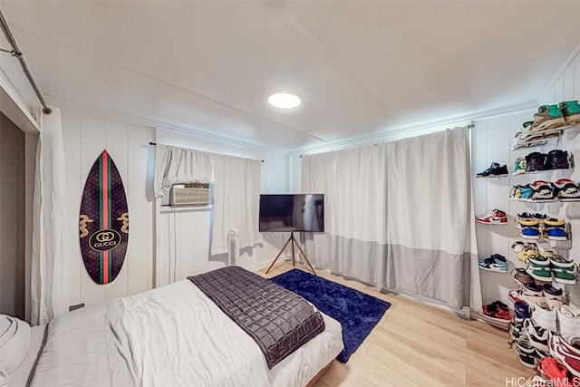 bedroom featuring cooling unit and light hardwood / wood-style floors