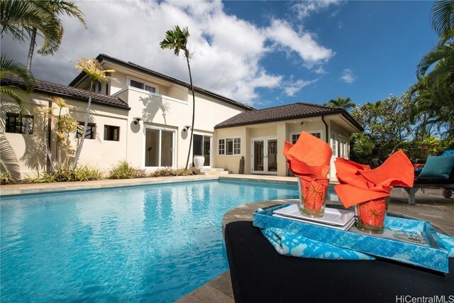 view of pool with french doors and a patio area