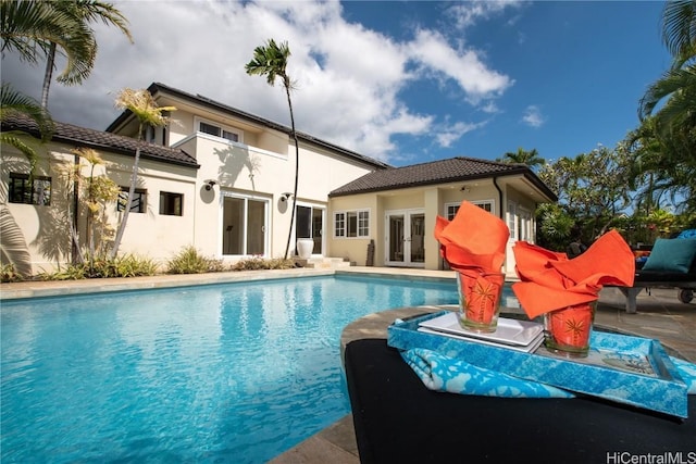 view of pool with a patio and french doors