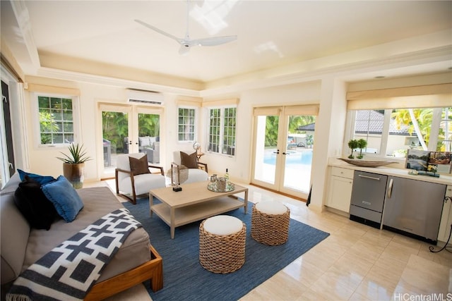 sunroom featuring ceiling fan, a tray ceiling, a wall unit AC, and french doors