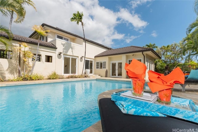 outdoor pool featuring french doors