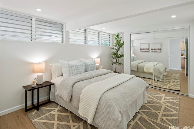 bedroom featuring hardwood / wood-style floors and a closet