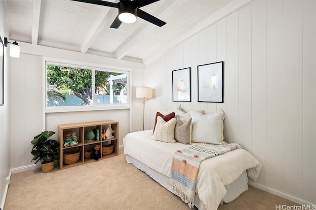 carpeted bedroom featuring ceiling fan and beam ceiling