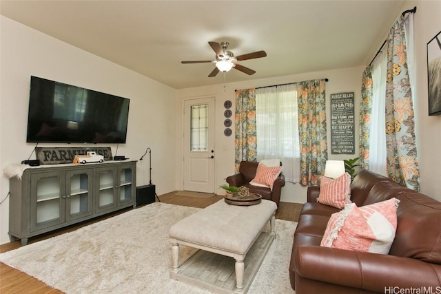 living room featuring hardwood / wood-style flooring and ceiling fan