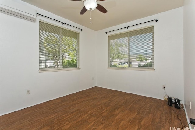 spare room featuring hardwood / wood-style flooring, ceiling fan, and a wall mounted air conditioner