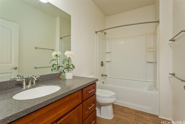 full bathroom featuring vanity, hardwood / wood-style floors, bathtub / shower combination, and toilet