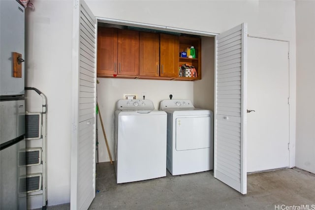 laundry area with cabinets and washing machine and clothes dryer