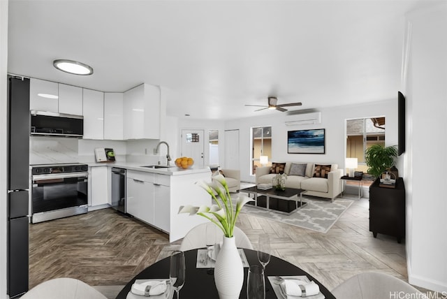 kitchen featuring range with electric cooktop, white cabinets, sink, and light parquet floors