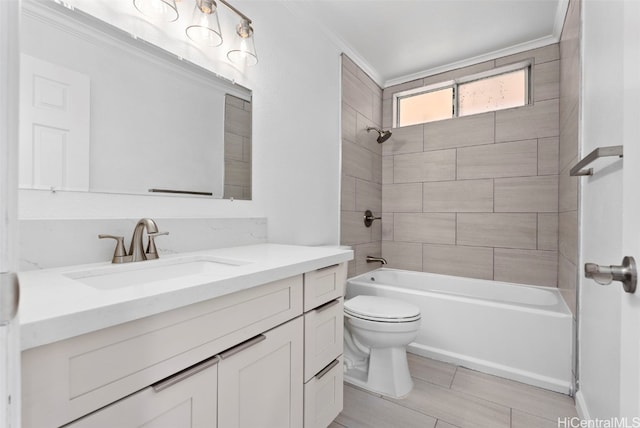 full bathroom featuring vanity, tiled shower / bath combo, ornamental molding, and toilet