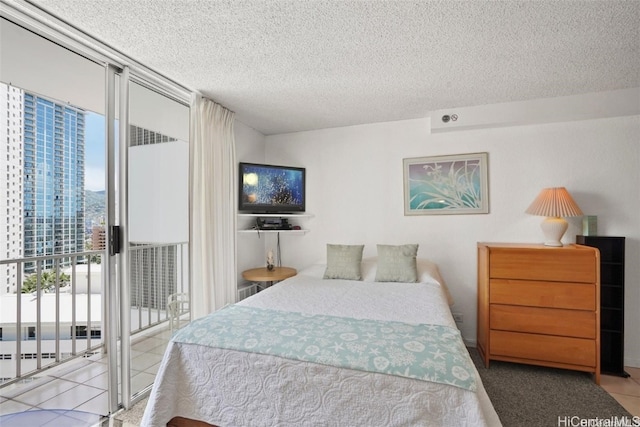 tiled bedroom featuring a wall of windows, access to exterior, and a textured ceiling