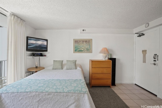 tiled bedroom with a textured ceiling