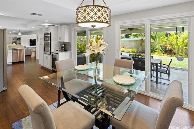 dining area with wine cooler and dark hardwood / wood-style floors