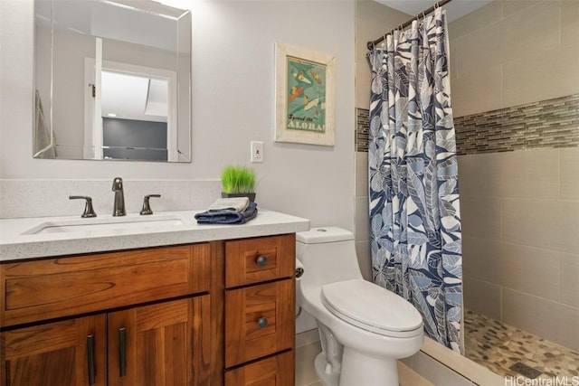 bathroom featuring vanity, toilet, and walk in shower