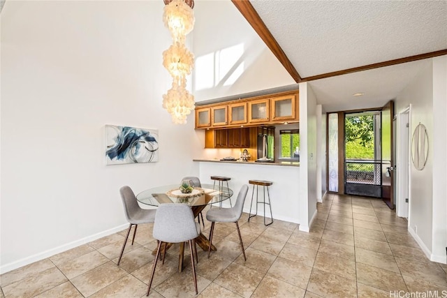 dining room with light tile patterned flooring, a chandelier, vaulted ceiling, and a textured ceiling