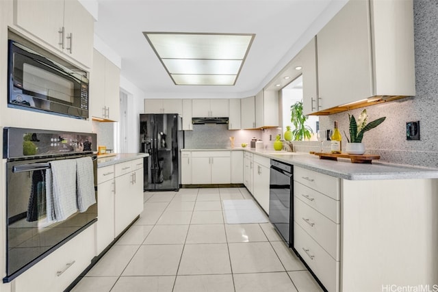 kitchen with light tile patterned flooring, sink, white cabinetry, black appliances, and backsplash