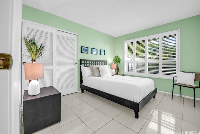 tiled bedroom with a closet